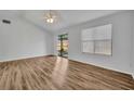 Bright, airy living room featuring wood-look floors, ceiling fan, and sliding glass door to patio at 1310 Oregon St, Orlando, FL 32803