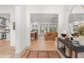 Open concept living area with hardwood floors, flowing into the kitchen and dining spaces at 1341 Place Picardy, Winter Park, FL 32789