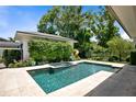 Tranquil backyard pool with a jacuzzi, surrounded by lush greenery and a privacy fence at 1341 Place Picardy, Winter Park, FL 32789