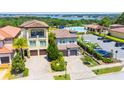 An aerial view of the home, community pool, parking, manicured lawns, and surrounding landscape at 16210 Ravenna Ct, Montverde, FL 34756