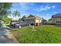 Home exterior featuring a two-car garage, mature landscaping, and a well-manicured lawn at 1956 Southern Dunes Blvd, Haines City, FL 33844