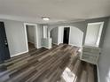 Spacious living room with wood floors, archways, and built in shelving at 2107 Hollywood Ave, Eustis, FL 32726