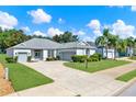 Attractive home showcasing a brick driveway, manicured lawn, and a covered front porch at 25105 Laurel Valley Rd, Leesburg, FL 34748