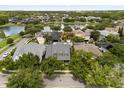 Stunning aerial view of the neighborhood with a beautiful lake and lush greenery at 3363 Morelyn Crest Cir, Orlando, FL 32828