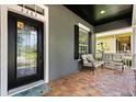 Cozy front porch with seating area, decorative door, and brick flooring at 3363 Morelyn Crest Cir, Orlando, FL 32828