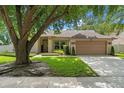 Charming single-story home with well-maintained lawn and front yard landscaping, featuring a two-car garage at 3618 Pompano Ct, Gotha, FL 34734