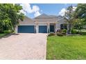 Charming home with a manicured lawn, two-car garage, and inviting entrance with updated stonework at 3994 Knott Dr, Apopka, FL 32712