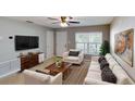 Bright living room with a ceiling fan, large window, and a comfortable seating arrangement at 435 Andes Ave, Orlando, FL 32807