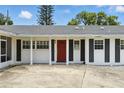 Close up of home's front door with white pillars and black shutters at 4611 Cranston Pl, Orlando, FL 32812