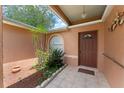 Inviting front entrance with a tiled porch and a cozy, landscaped garden area at 470 Cardinal Ct, Kissimmee, FL 34759