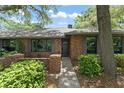 Well-maintained brick home featuring lovely landscaping and a welcoming front entrance at 473 Burnt Tree Ln, Apopka, FL 32712