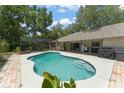 Inviting backyard pool with screened enclosure and an expansive patio area perfect for outdoor entertaining at 473 Burnt Tree Ln, Apopka, FL 32712