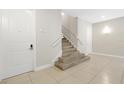 Interior view of a modern condo's stairway with a neutral color palette and tile flooring at 7770 Sandy Ridge Dr # 117, Reunion, FL 34747