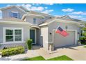 This eye-level view shows the front exterior with a green lawn, inviting curb appeal, and an attached two-car garage at 965 Maypole Dr, Apopka, FL 32703