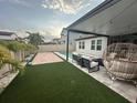 Well-maintained backyard with a pool, outdoor seating area under a pergola, and manicured landscaping at 9863 Summerlake Groves St, Winter Garden, FL 34787