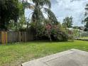Private backyard oasis featuring lush greenery and a mature bougainvillea, offering tranquility and beauty at 9923 Dean Acre Dr, Orlando, FL 32825