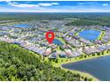 Beautiful aerial view of a Primary-planned community surrounded by serene lakes and lush greenery at 10091 Lovegrass Ln, Orlando, FL 32832