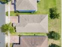Aerial view of home showcasing the roof, landscaping, and nearby homes in the neighborhood at 10091 Lovegrass Ln, Orlando, FL 32832