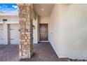 Inviting front entrance featuring a brick-paved walkway and a striking stone pillar accent at 10091 Lovegrass Ln, Orlando, FL 32832