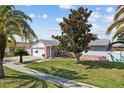 A charming single-story home with a well-manicured lawn and mature trees in a peaceful setting at 109 Woodfield Ct, Sanford, FL 32773