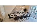 Dining room with a modern table set for ten, complemented by stylish decor and pool view at 1201 Challenge Dr, Davenport, FL 33896
