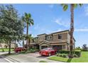Charming two-story home with a two-car garage, brick paved driveway, and a well-maintained lawn at 1269 Long Cove Loop # 1269, Davenport, FL 33896