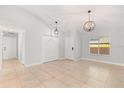 Open concept living space with tile flooring, updated light fixtures, and neutral paint colors at 1346 Palo Alto Ct, Winter Springs, FL 32708