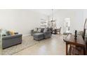 Bright living area with neutral colors, tile flooring, and a comfortable seating arrangement at 1400 Holly Glen Run, Apopka, FL 32703