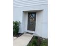 Inviting front door adorned with a decorative wreath, complementing the home's exterior at 1635 Wynford Cir, Tavares, FL 32778