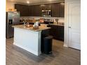Modern kitchen with stainless steel appliances, granite countertops, and a functional island at 1635 Wynford Cir, Tavares, FL 32778