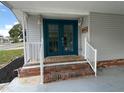 Inviting entrance featuring double doors and white railing at 164 Royal Palm Dr, Leesburg, FL 34748