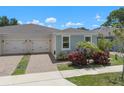 Charming home featuring a two-car garage, neatly landscaped front yard, and serene exterior at 1841 Overcup Ave, St Cloud, FL 34769