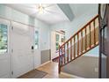 Bright foyer with tile flooring, staircase, and natural light from the front door at 201 Garden Ln, Longwood, FL 32750