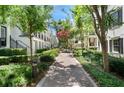 A well-maintained walkway with lush greenery leading to a row of elegant townhouses at 2036 Brink Aly, Orlando, FL 32814