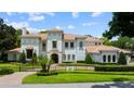 Beautiful two-story home with manicured landscaping, gated entrance, and a timeless Mediterranean design at 2211 Azalea Pl, Winter Park, FL 32789