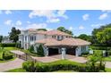 Expansive home featuring a porte cochere, well-maintained grounds, and an inviting entrance, ideal for entertaining at 2211 Azalea Pl, Winter Park, FL 32789