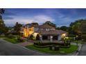 Stately home with covered parking, lush greenery, and distinctive architecture, perfect for luxurious living at 2211 Azalea Pl, Winter Park, FL 32789