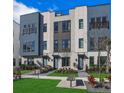 Modern townhome featuring manicured lawn, walkway, and a sleek architectural design at 2273 Valentine Aly, Orlando, FL 32804