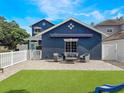 Charming backyard featuring a patio with outdoor seating and artificial grass, perfect for entertaining and relaxing at 2604 Marble Ave, Orlando, FL 32803