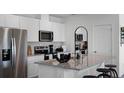 Modern kitchen featuring stainless steel appliances and granite countertops at 2696 Gouda Dr, Apopka, FL 32703