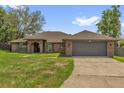 Charming brick home featuring an attached two-car garage and well-maintained landscaping at 3 Pine Glen Dr, Debary, FL 32713