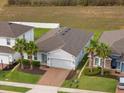 Charming single-story home with a brick driveway, attached garage and well-manicured lawn at 3142 Hill Point St, Minneola, FL 34715