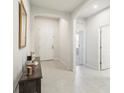 Inviting hallway features tiled floors, neutral walls, white doors, and arched entryways for an elegant appeal at 3142 Hill Point St, Minneola, FL 34715
