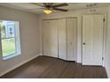 A bedroom featuring a ceiling fan and a closet with folding doors and a window at 3629 Main St, Sanford, FL 32771