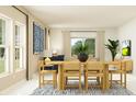 Bright dining area with large windows, a stylish table set, and comfortable seating at 431 Puma Loop, Groveland, FL 34736