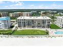 Aerial view showcases the waterfront condominium, pool, spa and tennis courts at 4631 S Atlantic Ave # 8102, Port Orange, FL 32127