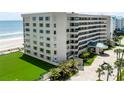 Multi-story condominium with a covered entryway and manicured lawn at 4631 S Atlantic Ave # 8102, Port Orange, FL 32127
