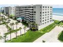 Multi-story condominium featuring a covered entryway and lush landscaping at 4631 S Atlantic Ave # 8102, Port Orange, FL 32127