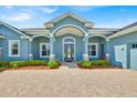 Front entry featuring brick pavers and a covered entryway at 5005 Shore Side Dr, Lakeland, FL 33812