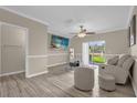 Bright living room featuring wood-look tile floors and sliding glass doors to the outside at 517 Wilton Cir, Sanford, FL 32773